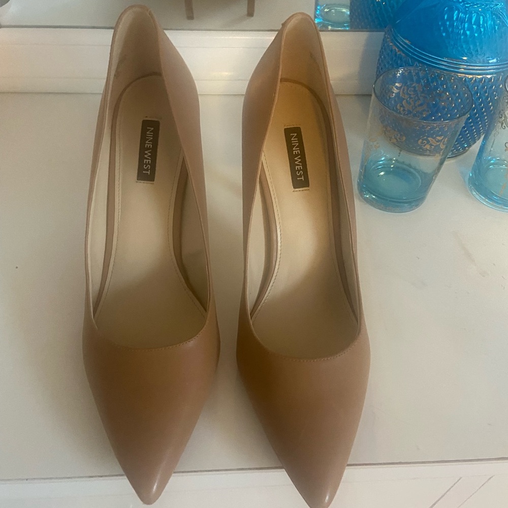 Nude, patent pumps.